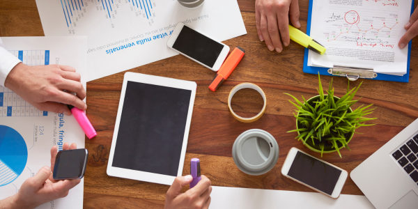 Desk with phones, tables and finance charts